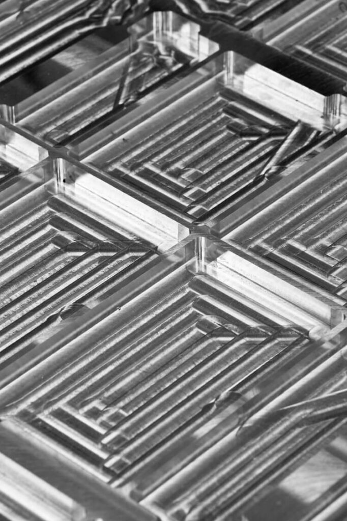 Close-up of precision CNC-manufactured metal parts with intricate patterns and grooves.