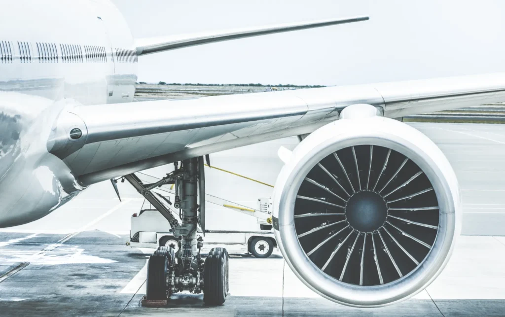 Airplane jet engine and landing gear showcasing precision engineering in aerospace manufacturing.
