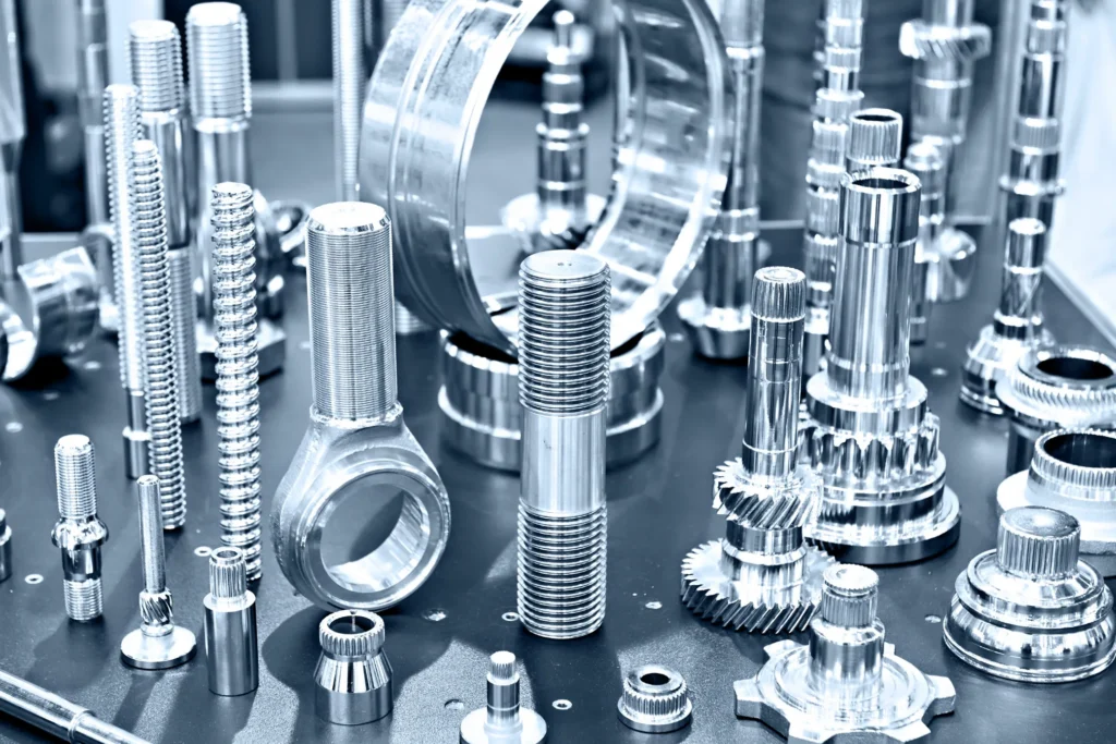Various precision CNC-manufactured metal components arranged on a surface.