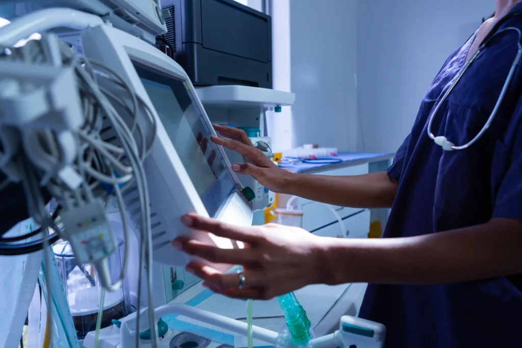 Medical professional using advanced technology equipment in a healthcare setting.