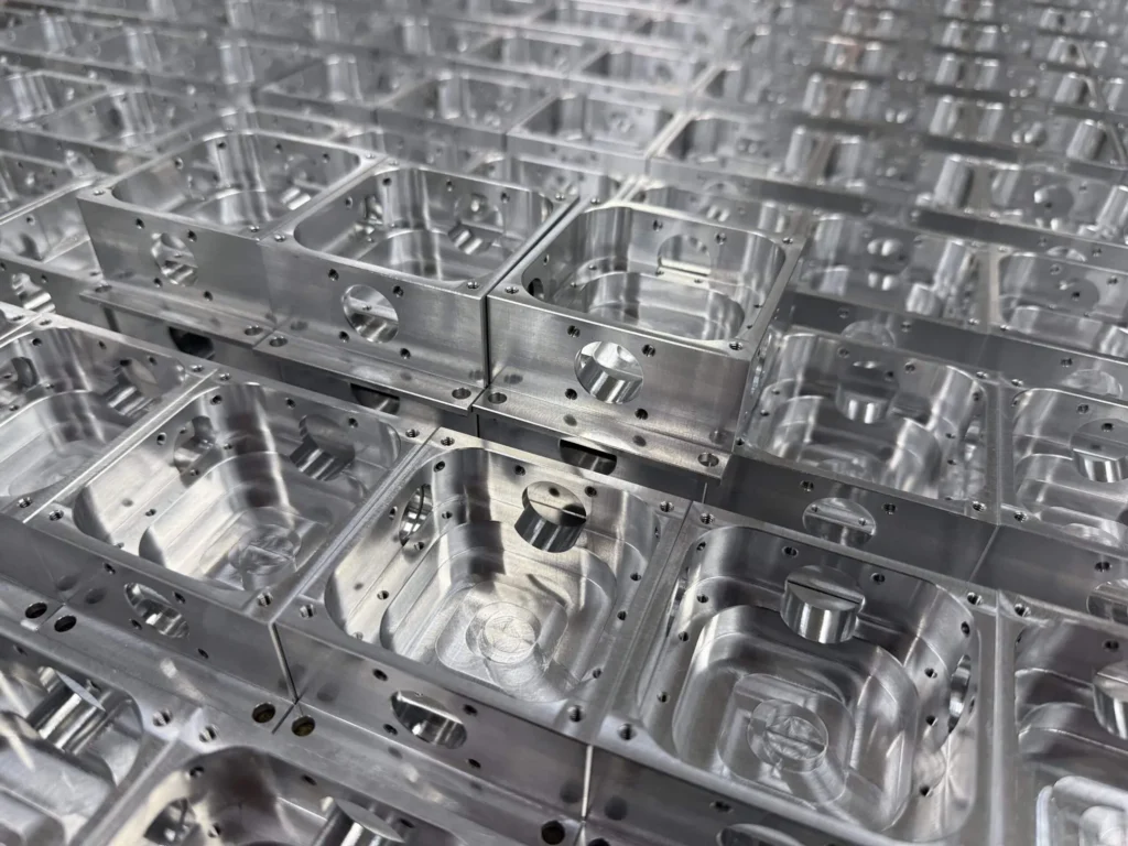 Precision CNC-manufactured metal components arranged in rows.