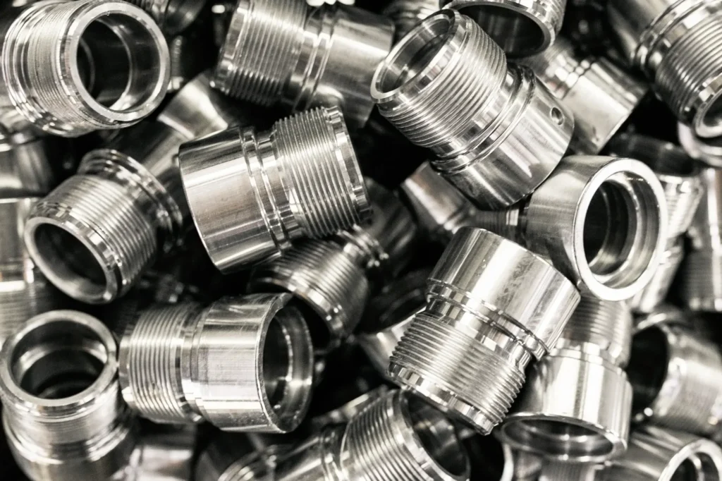 Precision CNC manufactured metal parts with threaded designs.